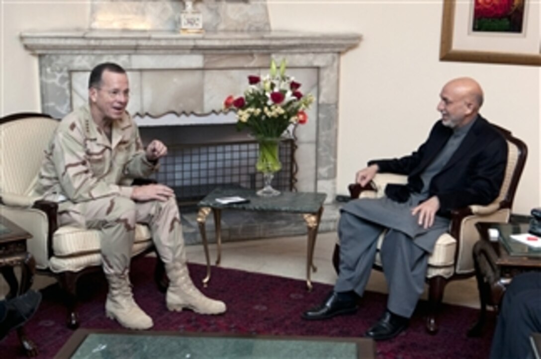 Chairman of the Joint Chiefs of Staff Adm. Mike Mullen, U.S. Navy, visits with Afghan President Hamid Karzai in Kabul, Afghanistan on Dec. 14, 2009.  Mullen and his wife Deborah are hosting the 2009 USO Holiday Troop Visit with tennis star Anna Kournikova, comedian Dave Attell, tennis coach Nicholas Bollettiere and musician Billy Ray Cyrus visiting troops in Afghanistan, Iraq and Germany.  