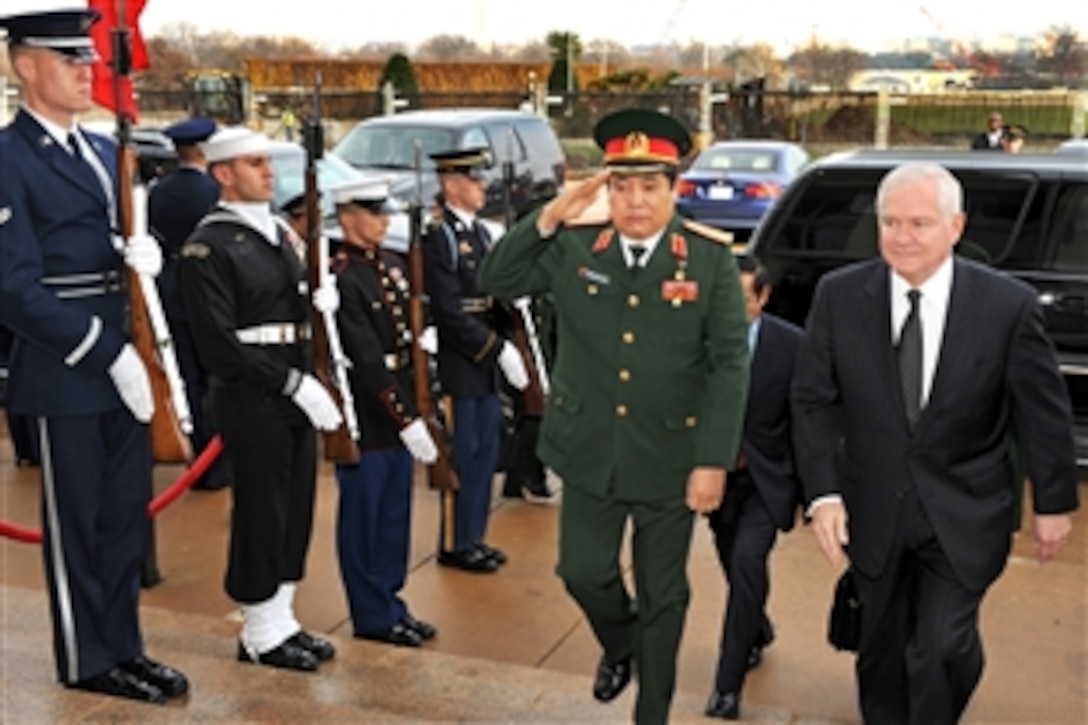 U.S. Defense Secretary Robert M. Gates, right. escorts Vietnamese National Defense Minister Gen. Phung Quang Thanh through an honor cordon into the Pentagon, Dec. 15, 2009, for security discussions.  