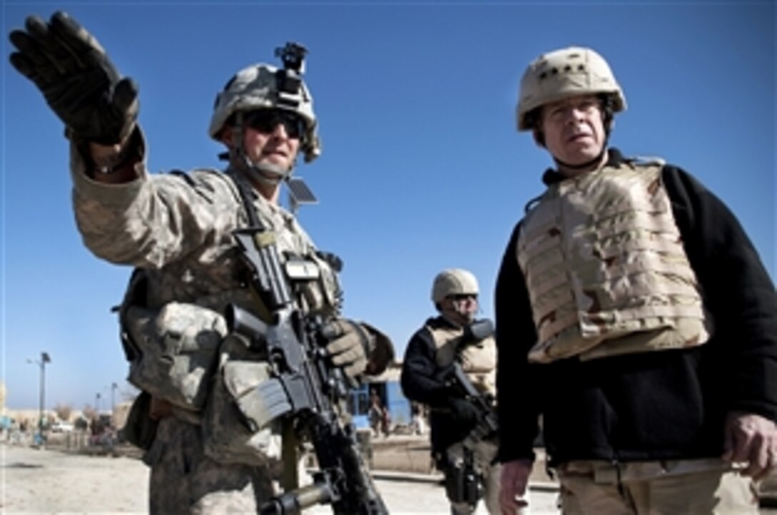 U.S. Army 1st Lt . John Billings points out aspects of the mission in the village of Mata Khan in Afghanistan's Paktika province to Navy Adm. Mike Mullen, chairman of the Joint Chiefs of Staff,  on his annual USO holiday tour, Dec. 15, 2009. Billings is a platoon leader assigned to the 501st Infantry's Blackfoot Company, 1st Battalion.