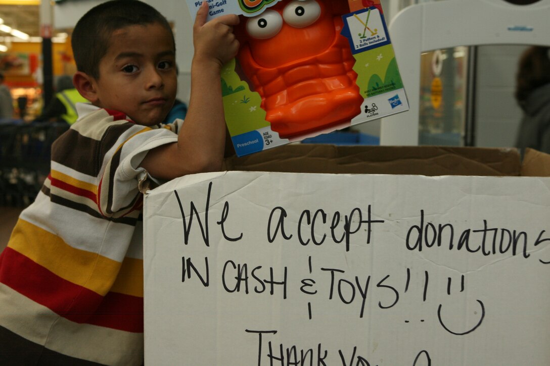 Victor K. Rocha, 5, from Oceanside, Calif., places a toy in a Toys for Tots box at Wal-Mart, Dec. 14. The Toys for Tots program collects new, unwrapped toys during the months of October, November and December each year and distributes those toys as Christmas gifts to needy children in the community. Anyone who'd like to donate a gift to Toys for Tots can visit the boxes located on Camp Pendleton and at a variety of stores off-base.