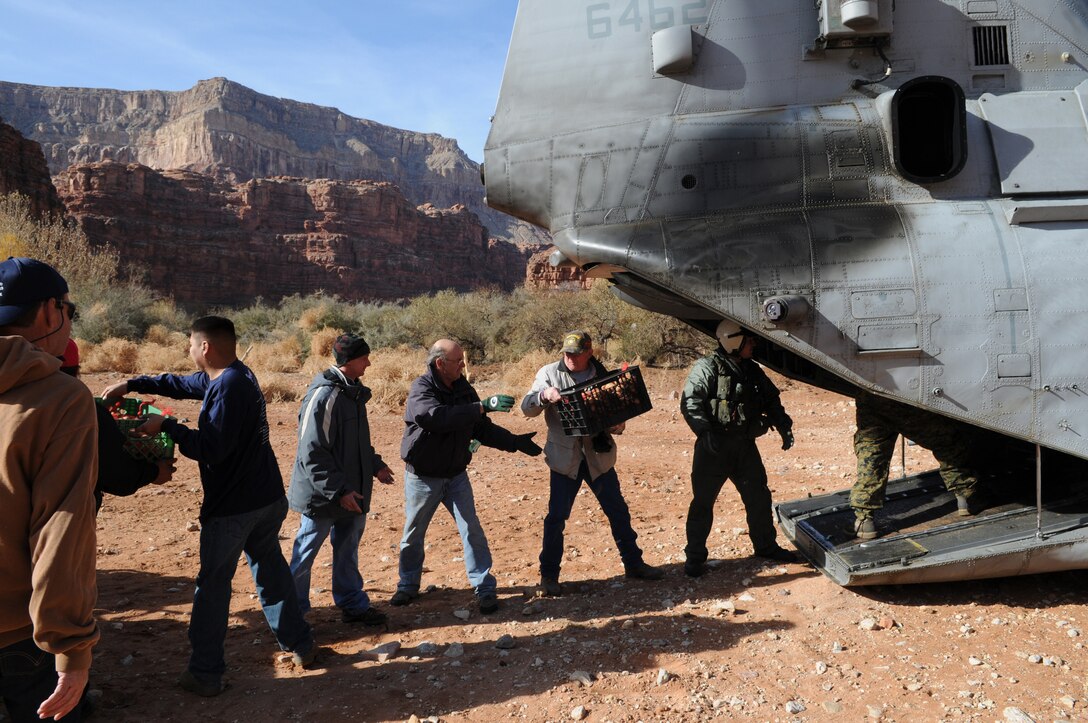 Marines and volunteers unload boxes of donated food from a CH-46 Sea Knight helicopter Dec. 15, 2009, at Supai, Ariz., a village within the Grand Canyon and the home of the Havasupai tribe. For 14 years, Marine Medium Helicopter Squadron 764, a reserve unit based at Edwards Air Force Base north of Los Angeles, has flown donated toys to the village. Besides airlift, the only way to reach the village is via an eight-mile foot trail.