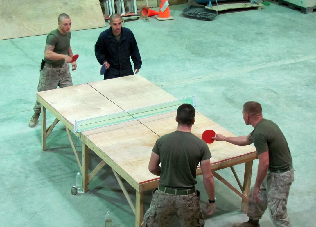 Marines from Company B, 3rd Combat Engineer Battalion, play a game of table tennis aboard Al Asad Air Base, Iraq, Dec. 16, 2009. Between route clearance missions, the CEB Marines find time to bond with one another through games and bonfires.