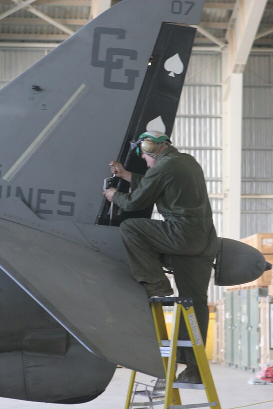 Lance Cpl. Brian Muoio, an airframes mechanic with Marine Attack Squadron 231, Marine Aircraft Group 40, Marine Expeditionary Brigade-Afghanistan, removes the rudder off of an AV-8B Harrier here Dec. 16. (U.S. Marine Corps photo by Lance Cpl. Samuel A. Nasso)