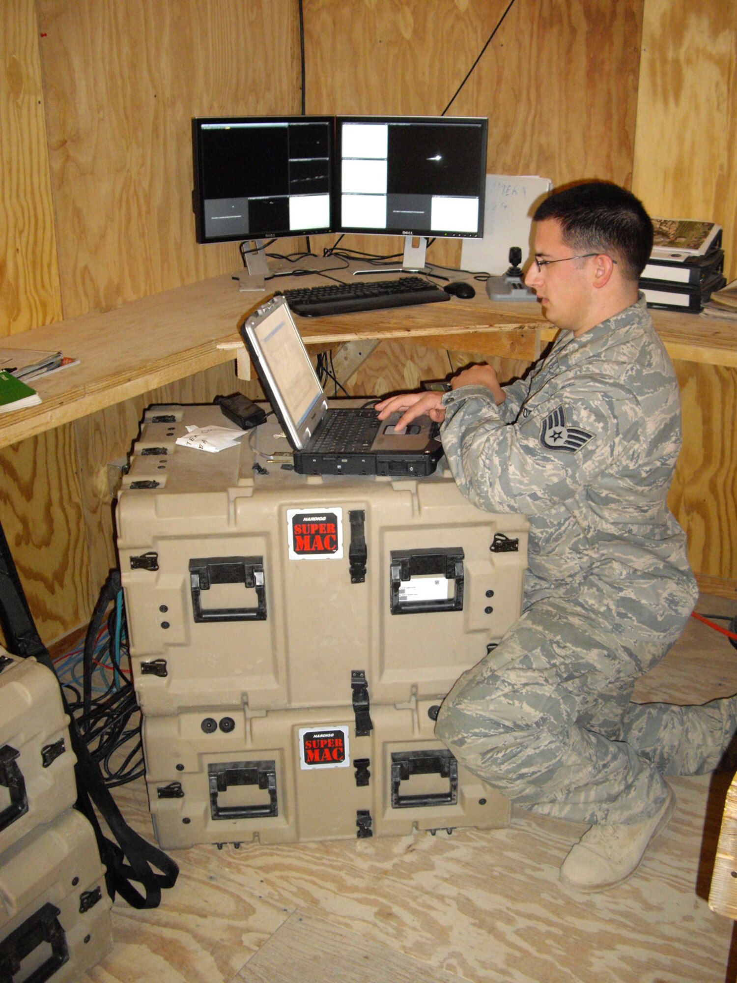 NURISTAN PROVINCE, Afghanistan - Staff Sgt. Shaun DeCroo, deployed from the 50th Communications Squadron, Scheiver Air Force Base, Colo., works on a ruggedized laptop to help set up critical internet communications for Soldiers. Sergeant DeCroo is a nine-year Air Force veteran and native of New Kensington, Pa., and serves as the only Airman in an Army Combat Outpost in a remote section of Afghanistan. (U.S. Air Force photo/Master Sgt. Todd Triplett)