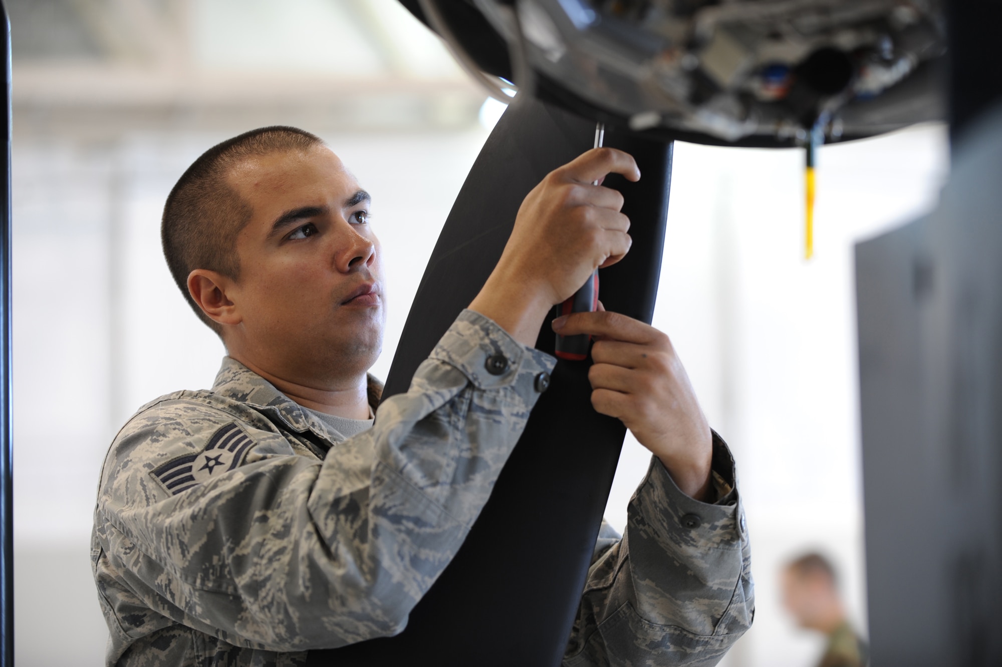 CREECH AFB Nev. -- Staff Sergeant James Healy, 432d Aircraft Maintenance Squadron crew chief, conducts maintenance operations on a remotely piloted aircraft here Nov. 3. The 432nd Aircraft Maintenance Squadron provides Predator MQ-1B and Reaper MQ-9 aircraft and equipment in support of worldwide expeditionary operations, USAF Weapons School and Predator formal training unit training, and operational test and evaluation customers. (U.S. Air Force photo/Tech. Sgt. Michael Holzworth)  