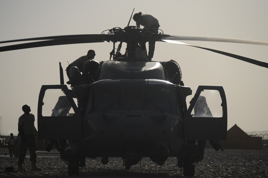 A maintenance crew works on an HH-60G Pave Hawk helicopter from the 129th Rescue Wing in Afghanistan, June 25, 2009. (U.S. Air Force photo by Staff Sgt. Shawn Weismiller)