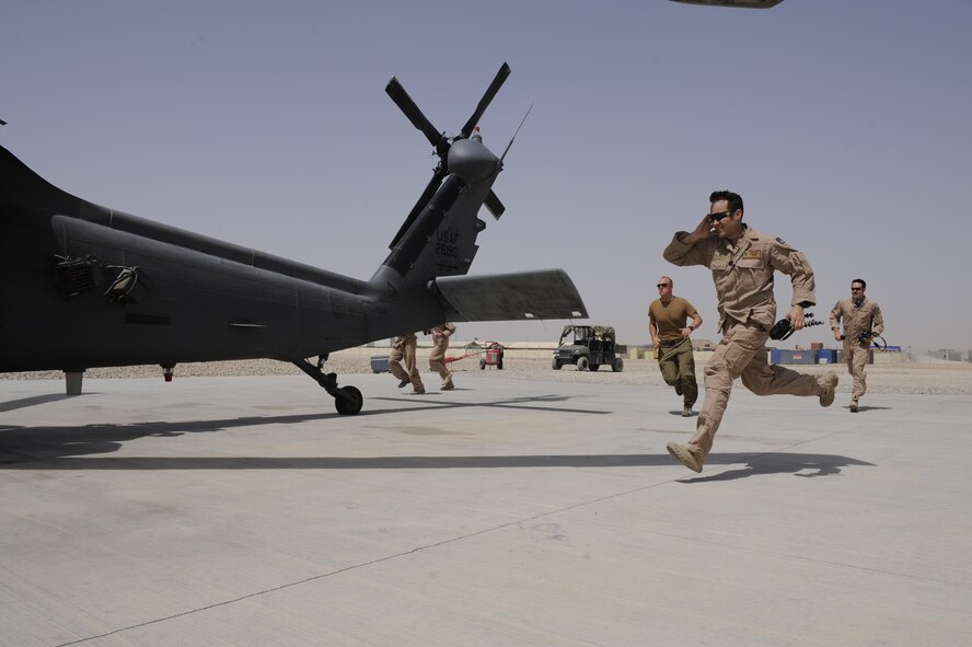 HH-60G Pave Hawk helicopter aircrews and maintainers based from the 129th Rescue Wing rush to their helicopter prior to launching a rescue mission in Afghanistan, June 24, 2009. (U.S. Air Force photo by Staff Sgt. Shawn Weismiller)