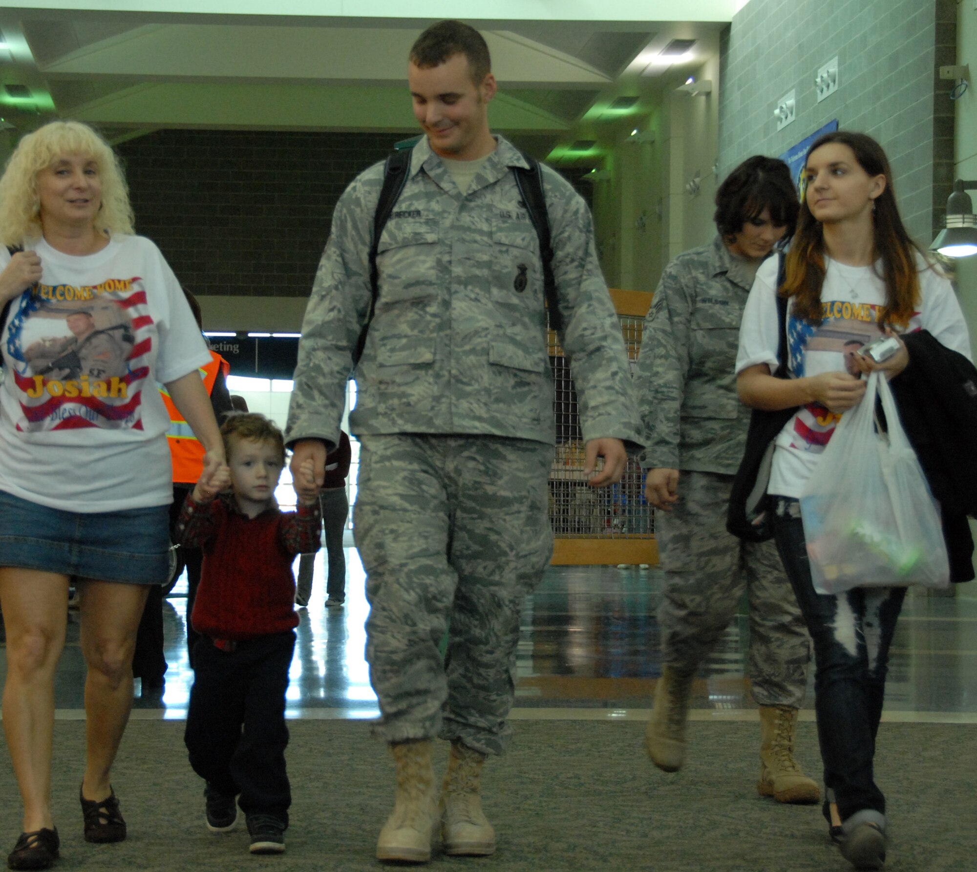 Staff Sgt. Josiah Strecker, 96th Security Forces Squadron, walks with his family to the bag claim area upon returning from a deployment to Southwest Asia Dec. 16.  Approximately 20 Security Forces Airmen returned.  Security forces is one of the highest deployment-tasked career fields in the Air Force.  (Air Force photo/ Samuel King Jr.)