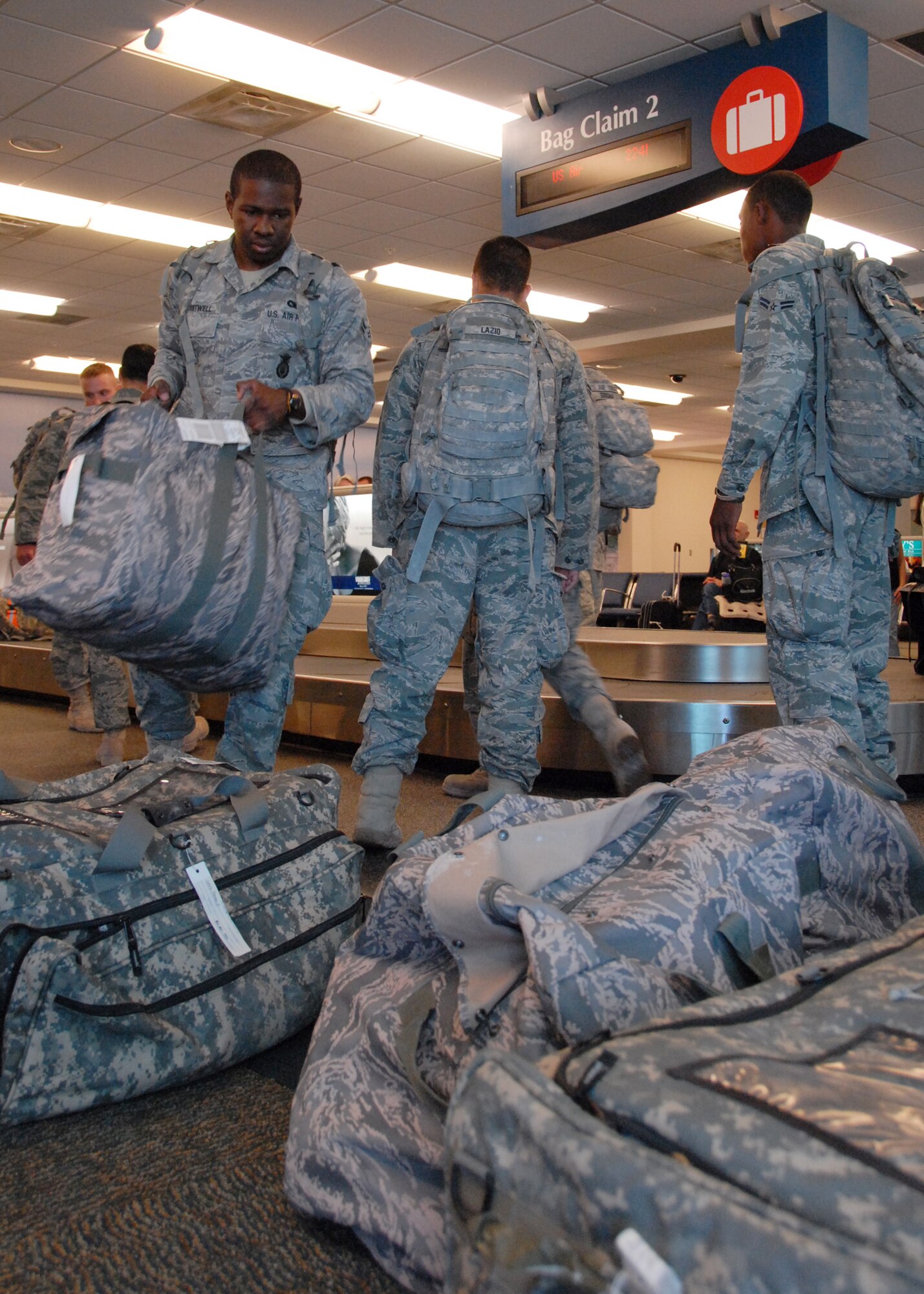 Security Forces Airmen pull bags upon returning from a deployment to Southwest Asia Dec. 16.  Approximately 20 Security Forces Airmen returned.  Security forces is one of the highest deployment-tasked career fields in the Air Force.  (Air Force photo/ Samuel King Jr.)