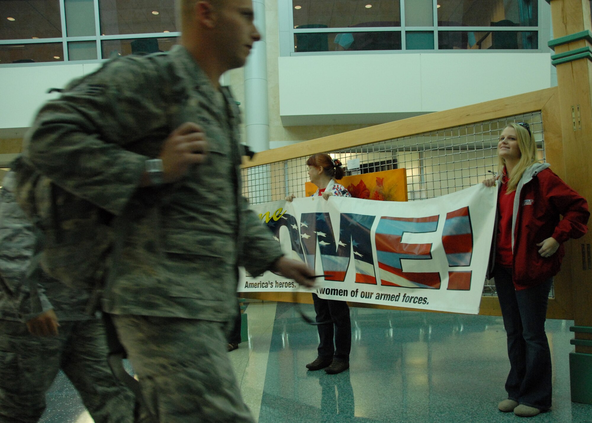 Community members and military supporters hold up “welcome home” signs as 96th Security Forces Squadron Airmen return from a deployment to Southwest Asia Dec. 16.  Approximately 20 Security Forces Airmen returned.  Security forces is one of the highest deployment-tasked career fields in the Air Force.  (Air Force photo/ Samuel King Jr.)