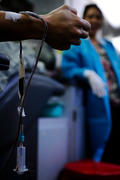 Senior Airman Troy McKee, 1st Special Operations Logistic Readiness Squadron, increases blood flow by squeezing a stress ball during a blood drive held at Hurlburt Field Dec. 15. The NWFBS exceeded their goal of obtaining 35 units of blood. (Air Force photo by Senior Airman Julianne Showalter)