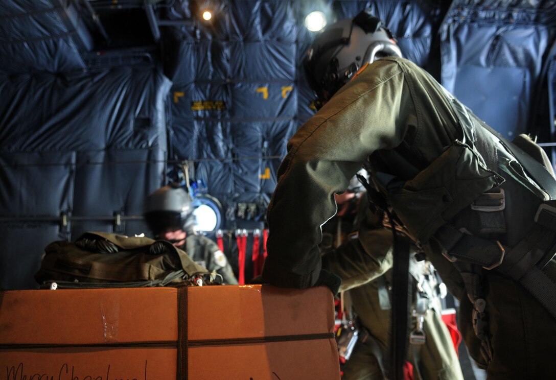 CHUUK ISLANDS - Members of the 36th Airlift Squadron prepare a pallet of boxed donations to be dropped to its planned location in the Chuuk Islands as part of Operation Christmas Drop Dec. 16. Operation Christmas Drop, which began in 1952, is the Air Force's longest-running humanitarian mission. Airmen today continue the tradition delivering supplies to remote islands of the Commonwealth of the Northern Marianas Islands, Yap, Palau, Chuuk and Pohnpei.   (U.S. Air Force photo by Airman 1st Class Julian North)