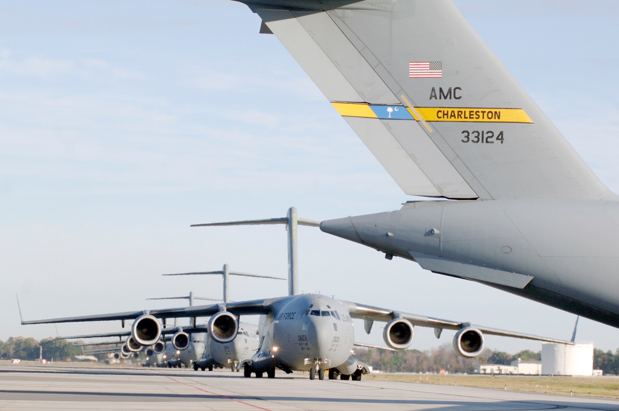 C-17 Globemaster IIIs from Charleston Air Force Base, S.C., taxi prior to take-off in preparation for a strategic brigade airdrop exercise over North Auxiliary Airfield Dec. 16, 2009, near North, S.C. Charleston AFB Airmen conducted a large formation exercise utilizing 10 C-17 aircraft. Soldiers from the 2-319th Airborne Field Artillery, 82nd Airborne Division, Ft. Bragg, N.C., were airdropped along with cargo pallets to simulate the seizure of a remote airfield. (U.S. Air Force photo/Staff Sgt. Marie Brown)