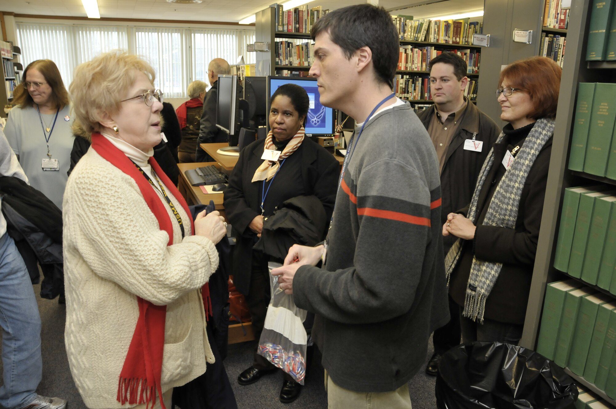Fred Rascoe, Information International Associates’ team lead at the AEDC Technical Library, listens to a question posed by Carol Koenig, librarian with the Army’s National Ground Intelligence Center in Charlottesville, Va. during a visit Dec. 11 from 30 military librarians who had attended the Special Library Association’s annual conference in Nashville. (Photo by Rick Goodfriend)