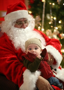 Gavin, son of Staff Sgt. Sue Hemgesberg, 59th Laboratory Squadron, sits in Santa's lap during the children's holiday party at the Skylark Community Center Dec. 12. The children's holiday party included games, crafts, prizes, food and music. (U.S. Air Force photo/Robbin Cresswell) 