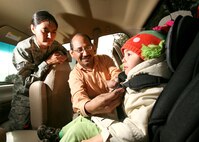Roy Gutierrez, a certified child passenger technician with the 37th Training Wing Safety Office, shows Staff Sgt. Leubinka Romero how to properly strap and adjust her daughter Isabella into a car seat. The safety office offers assistance on the proper selection and installation of car seats; call 671-3969 for an appointment. Certified technicians are also available by appointment at each of the base child development centers and the youth center for enrolled families. (U.S. Air Force photo/Robbin Cresswell)