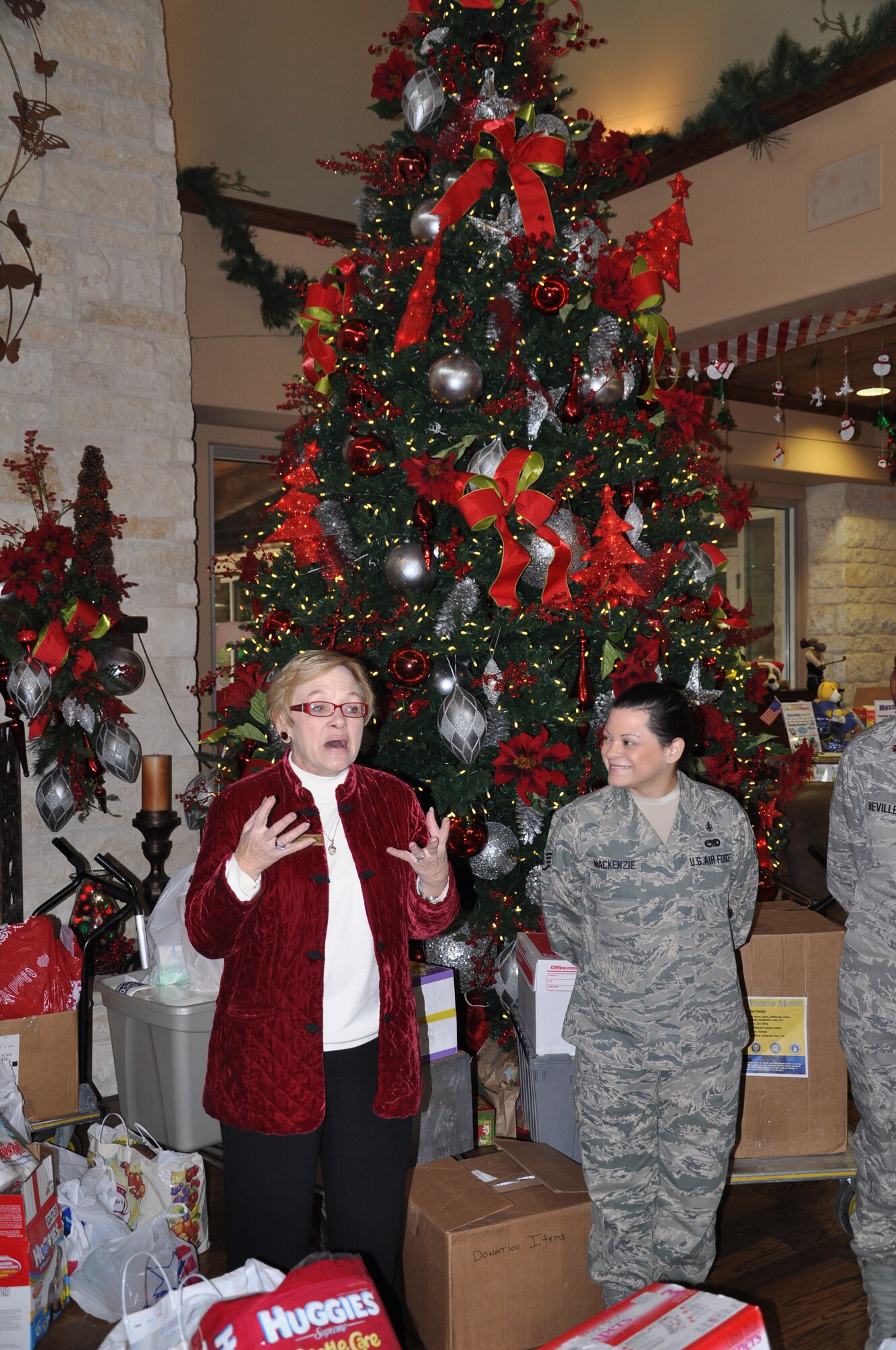 Warrior and Family Support Center Program Manager Judith Markelz (left) expresses her thanks to Air Force Staff Sgt. Dawn MacKenzie Dec. 15 for the money and items donated as part of the Wounded Warrior Donation Drive at Lackland Air Force Base. (U.S. Army photo by Steve Elliott)

