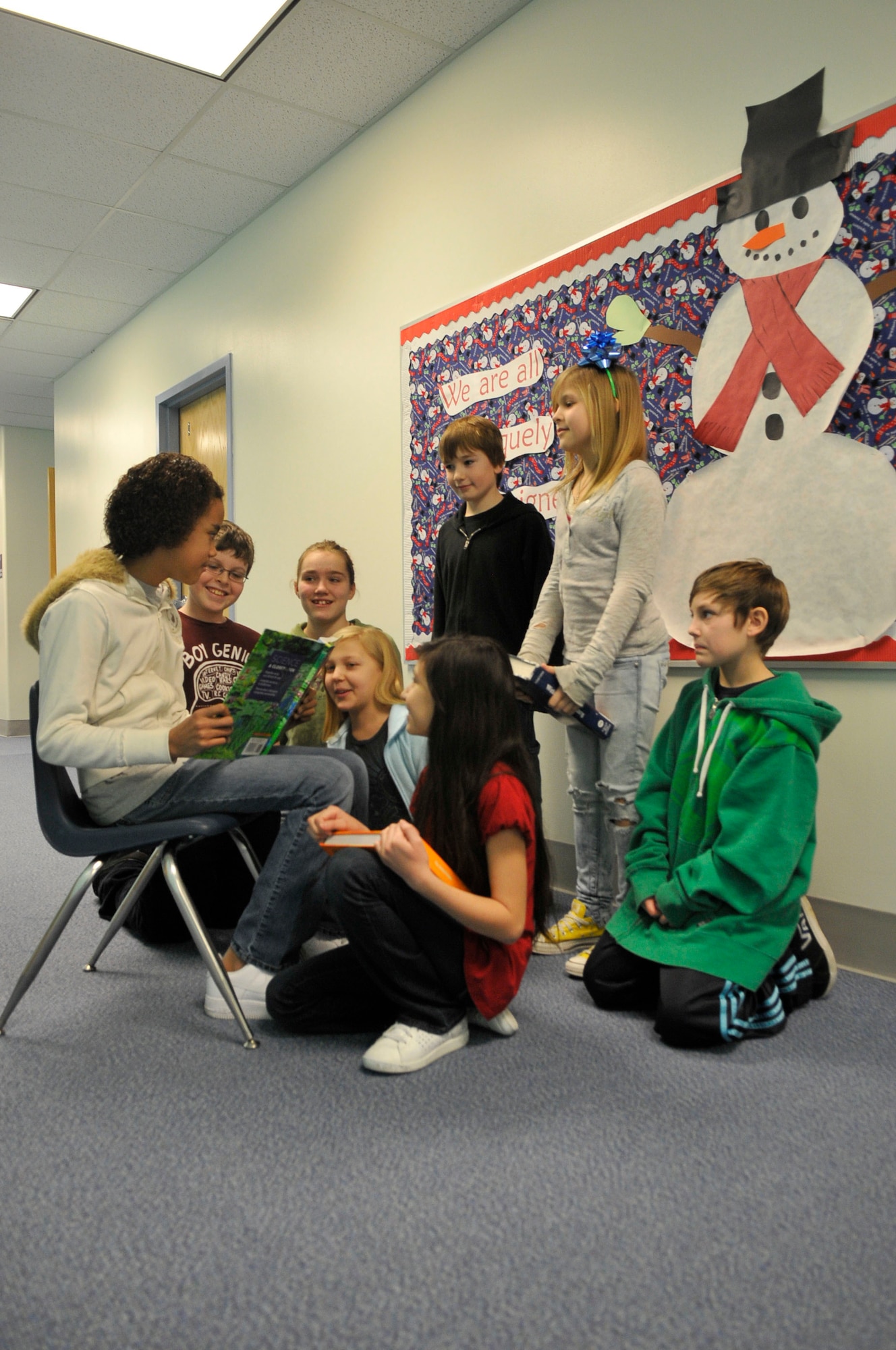 Students gather around to demonstrate a way they would share the holiday spirit Dec. 15, 2009, Eielson Air Force Base, Alaska. The students gave their opinions in a questionnaire highlighting good will and happiness during the holidays. The students are in Mrs. Ellingson's 5th grade class at Crawford Elementary School. (U.S. Air Force photo/Airman 1st Class Janine Thibault) 
