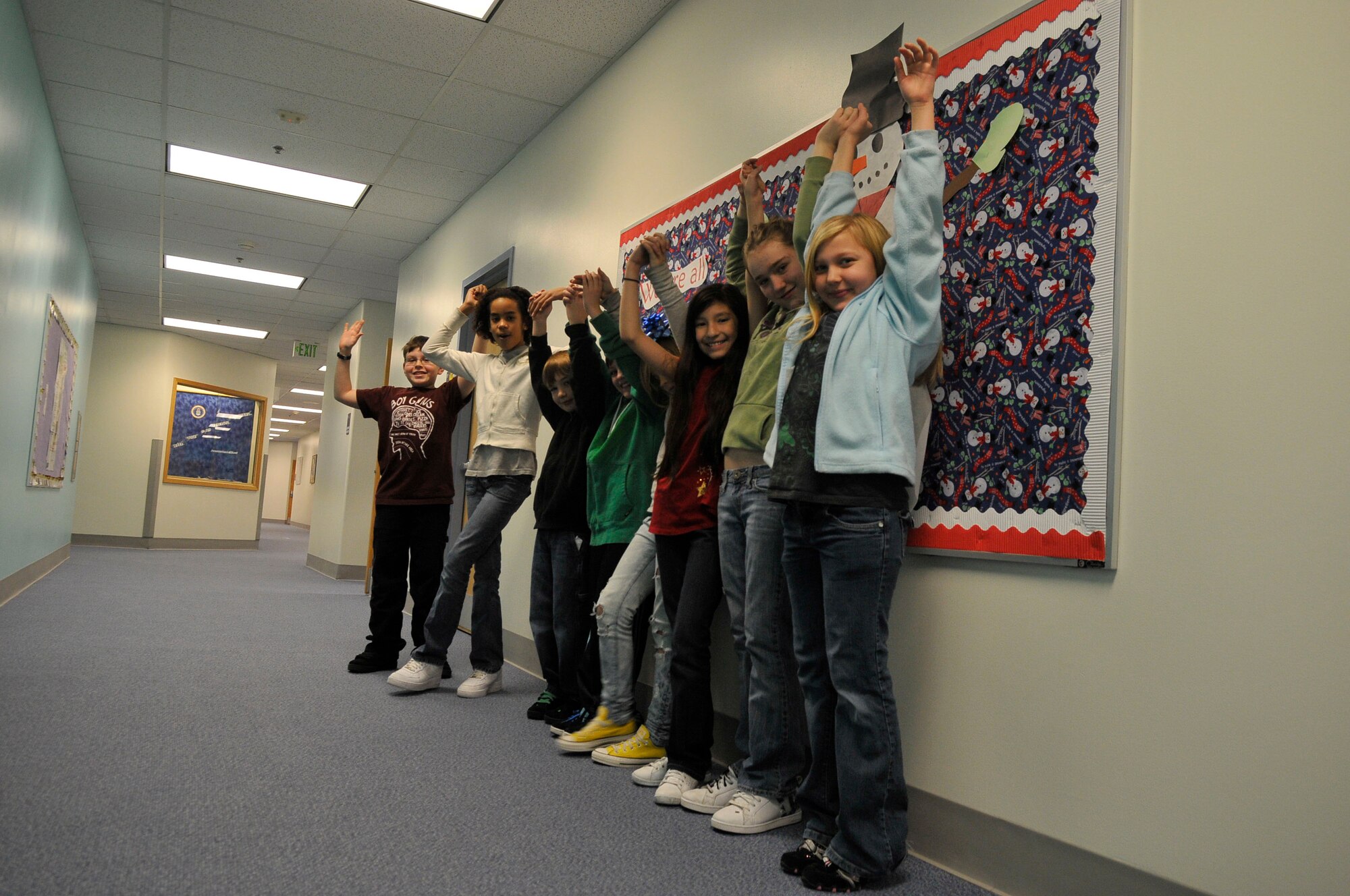 Students raise their hands in celebration of the holidays Dec. 15, 2009, Eielson Air Force Base, Alaska.The students gave their opinions in a questionnaire highlighting good will and happiness during the holidays. The students are in Mrs. Ellingson's 5th grade class at Crawford Elementary School. (U.S. Air Force photo/Airman 1st Class Janine Thibault) 