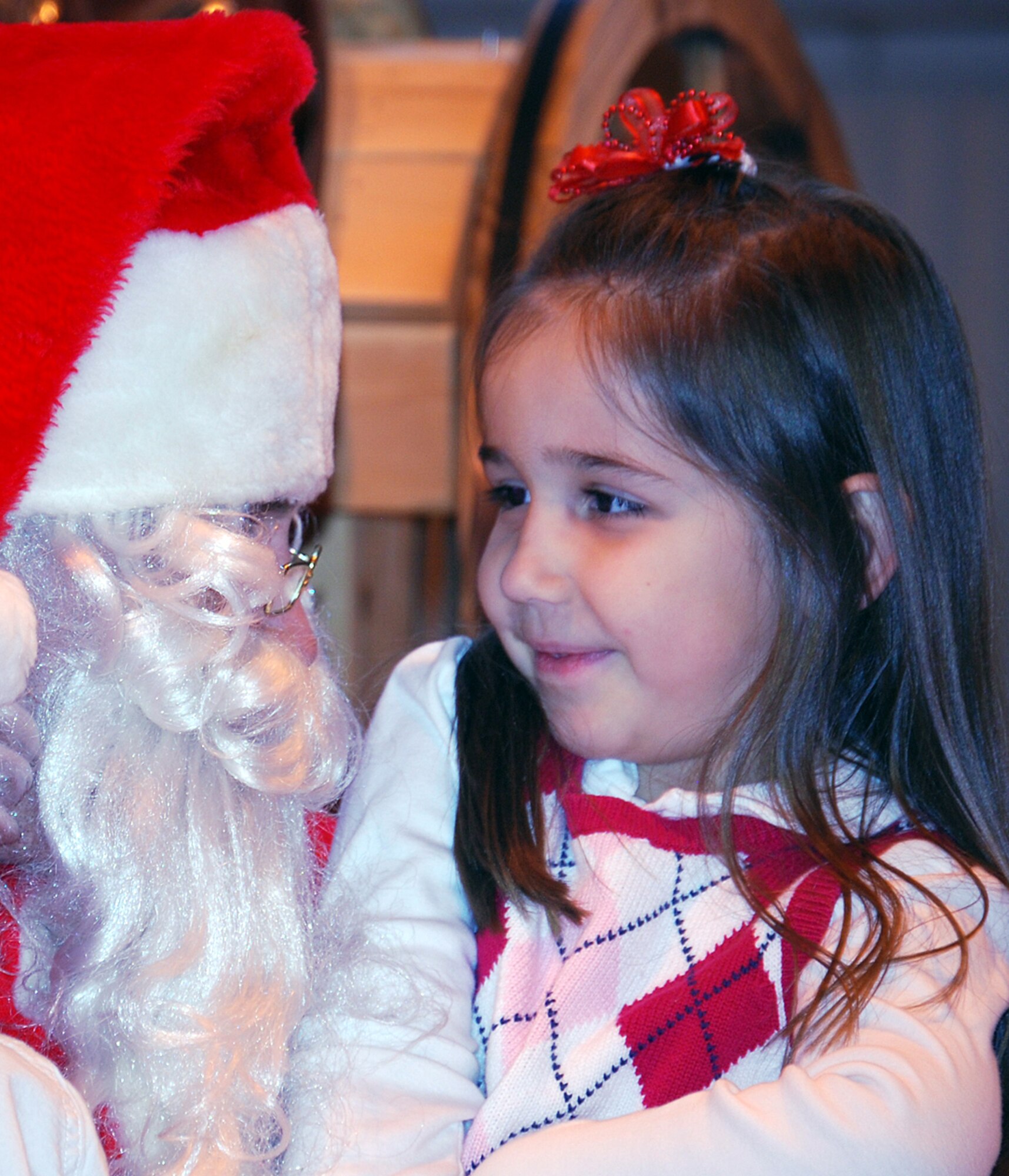 Sarah Ulmer was the first to sit on Santa’s lap during Brunch with Santa, Dec. 12, in Hangar 170. More than 600 Team Vance members and their families attended the event. Sarah is the daughter of Capt. Jeff Ulmer, an instructor pilot with the 32nd Flying Training Squadron. (Photo by Ashley Murphy)