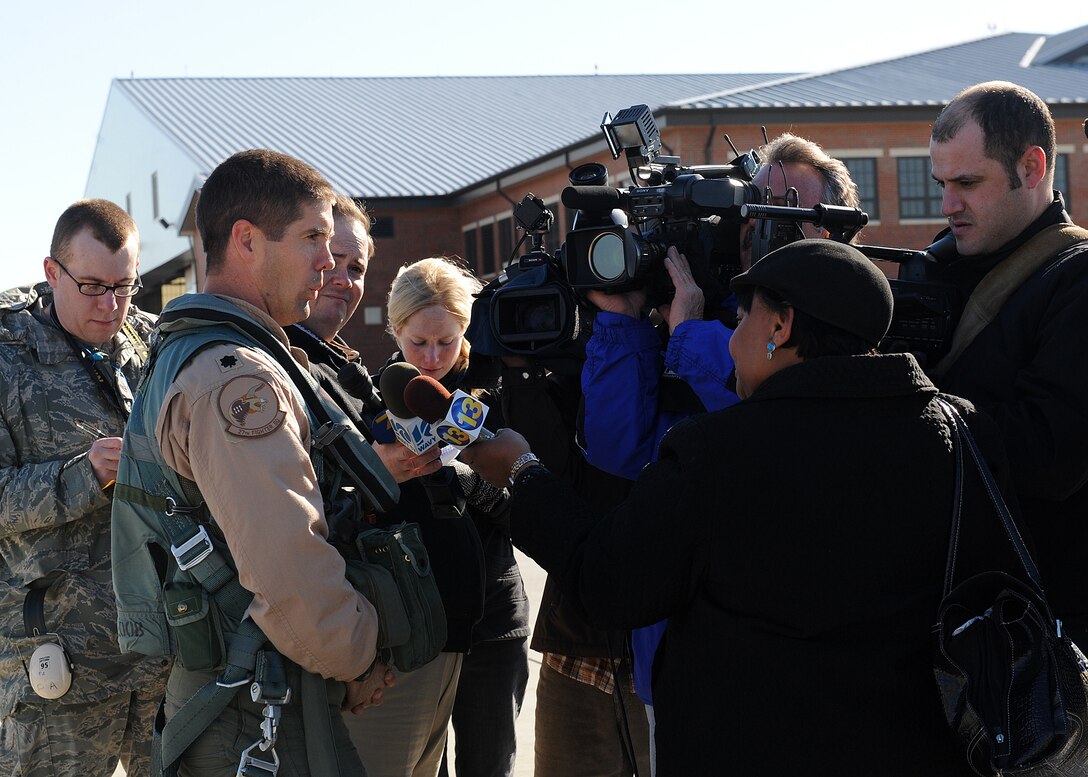 LANGLEY AIR FORCE BASE, Va. -- Lt. Col. Lansing Pilch, 27th Fighter Squadron commander, is interviewed by local media after returning from a deployment Dec. 16. The 27th FS deployed six F-22 Raptors in support of a 40-day training exercise in southwest Asia. (U.S. Air Force photo/Airman Rebecca Montez) 