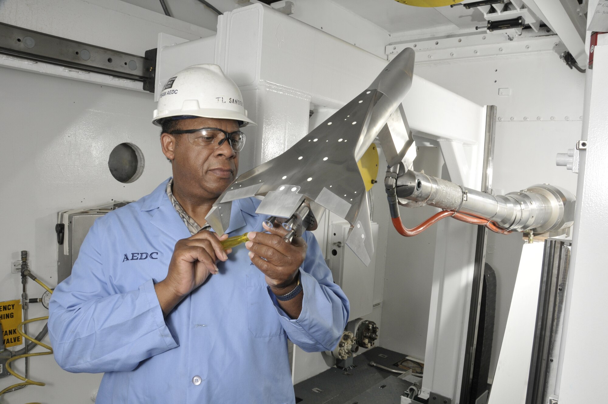 Aerospace Testing Alliance Outside Machinist Jimmy Sanders cleans and inspects the upper surface of a 4-percent model of the Fully-Reusable Access to Space Technology proof-of-concept launch vehicle during a model change prior to the resumption of aerodynamic testing AEDC’s von Kàrmàn Gas Dynamics Facility (VKF) Supersonic Wind Tunnel A. (Photo by David Housch) 
