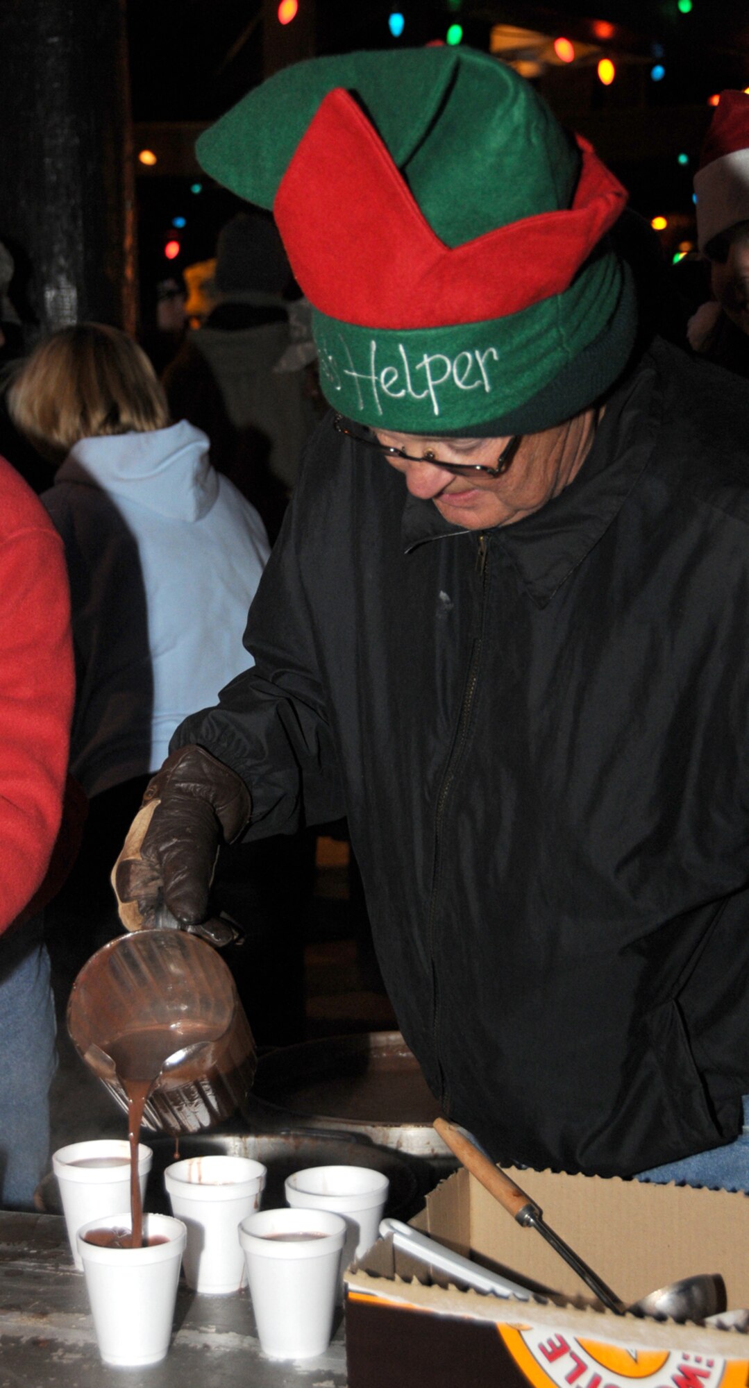 Doug Stiles, a retired senior master sergeant, pours hot cocoa.  He and three other volunteers poured 20 gallons of cocoa in the first hour of the festivities.   (U.S. Air Force photo by Tech. Sgt. Charles Marsh)
