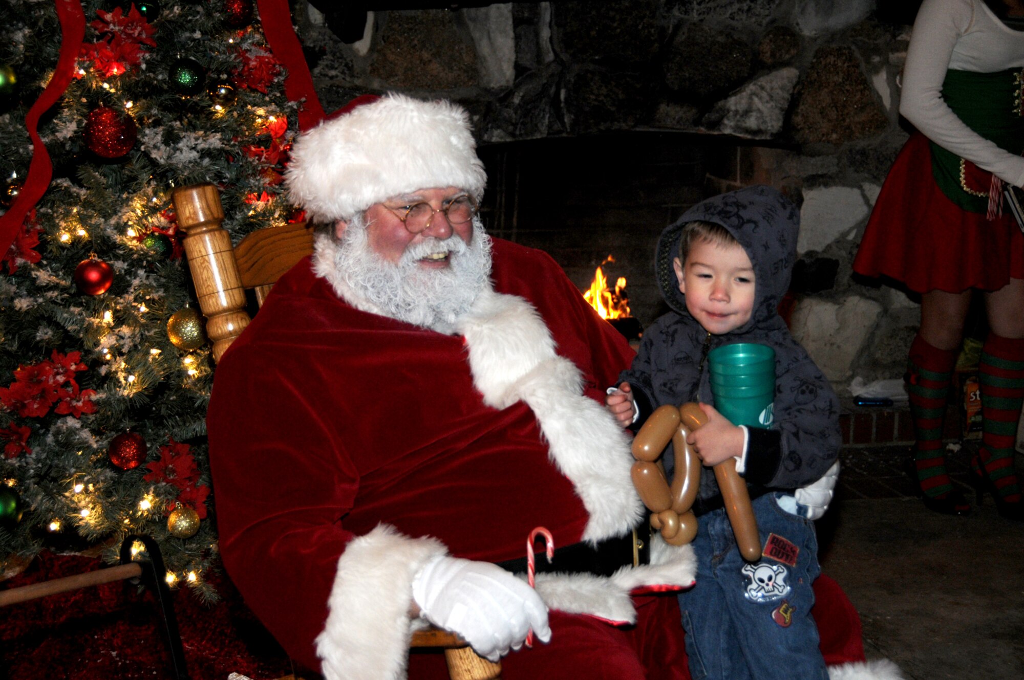 Three-year-old Kale Minervine goes over his Christmas list with Santa at Christmas in the Park, Dec. 10.  His mom is Staff Sgt. Jennifer Minervine, 81st Diagnostics and Therapeutics Squadron.  (U.S. Air Force photo by Tech. Sgt. Charles Marsh)
