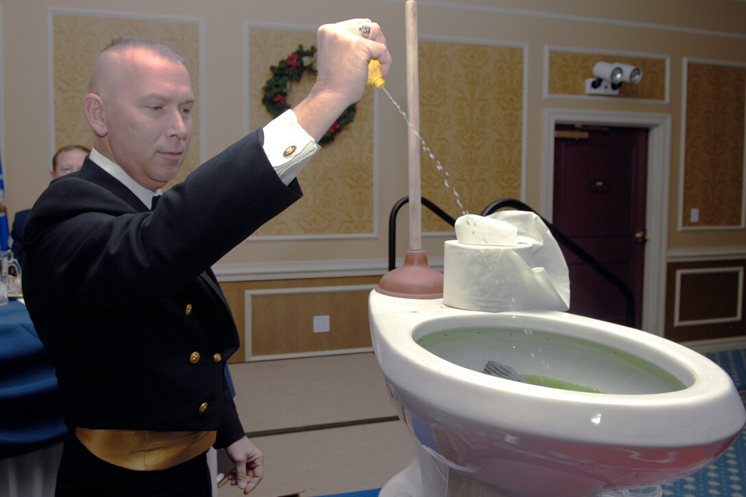 LANGLEY AIR FORCE BASE, Va. -- Command Master Chief Petty Officer Jon Port, helps prepare the grog for the enlisted dining in Dec. 11. The focus of the dining in was to celebrate the 50th anniversary of the rank of Chief Master Sgt. The rank was introduced into the United States Air Force Dec. 1, 1959. (U.S. Air Force photo/Staff Sgt. Jeff Nevison)