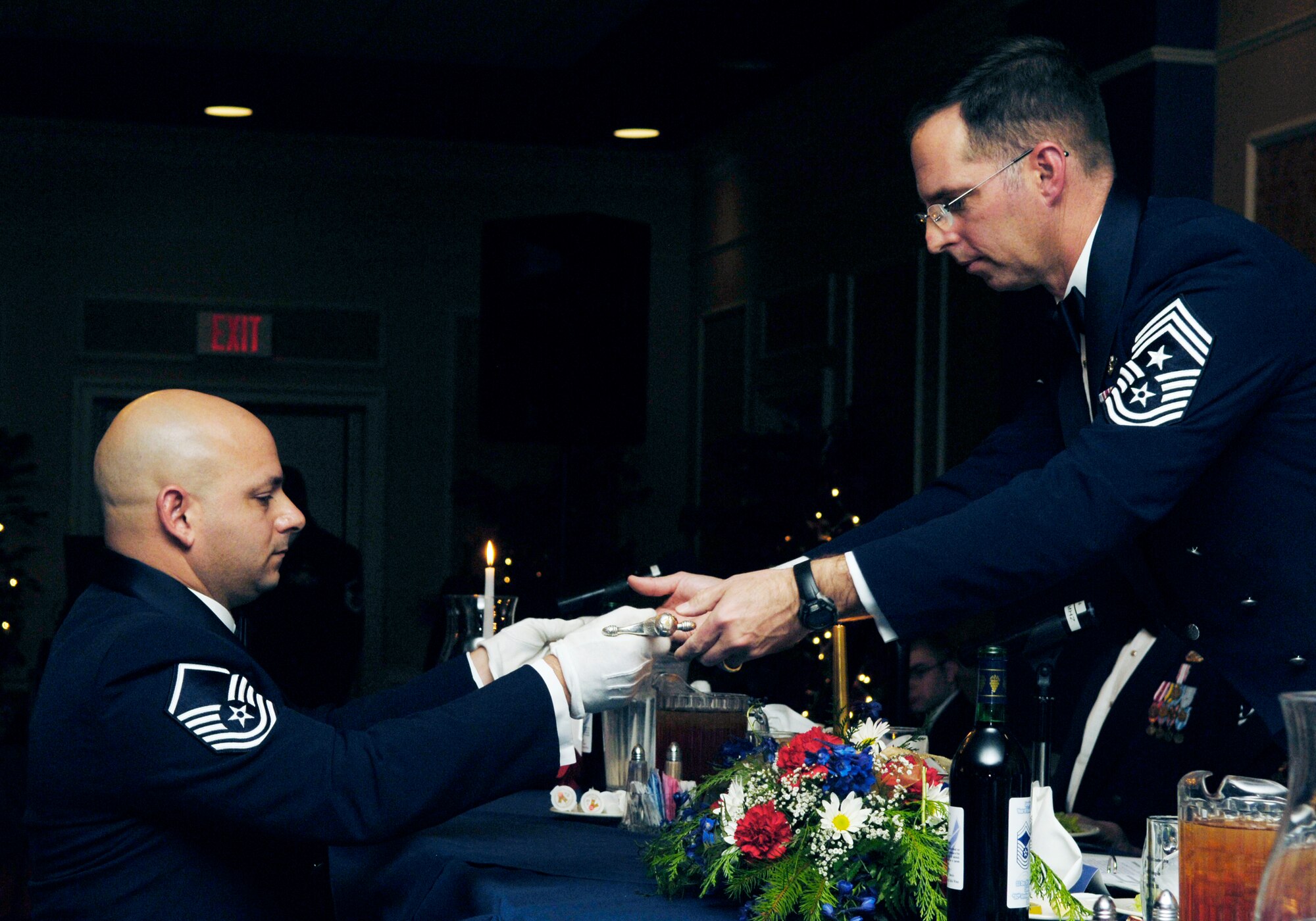 LANGLEY AIR FORCE BASE, Va. -- Master Sgt. Jason Colon, enlisted dining in sergeant-at-arms, presents arms to Chief Master Sgt. Kevin Jurgella,president of the mess, during the enlisted dining Dec. 11. The focus of the dining in was to celebrate the 50th anniversary of the rank of Chief Master Sgt. This rank was introduced into the United States Air Force Dec. 1, 1959. (U.S. Air Force photo by Staff Sgt. Jeff Nevison)