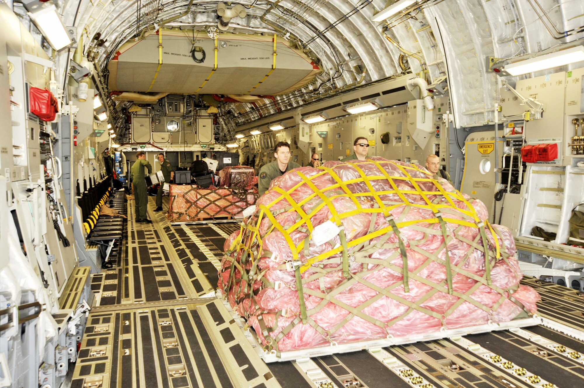 Airmen from the multinational Heavy Airlift Wing based at Papa Air Base, Hungary, unload a C-17 Globemaster III at Baghdad International Airport, Iraq. The airlift into Iraq was a first by the wing and facilitated the deployment for members of the NATO Training Mission-Iraq. The wing operates three C-17s and includes NATO member nations Bulgaria, Estonia, Hungary, Lithuania, the Netherlands, Norway, Poland, Romania, Slovenia and the U.S., as well as Partnership for Peace nations Finland and Sweden. (U.S. Air Force photo)