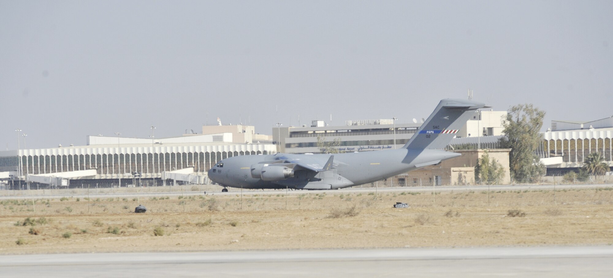 A C-17 Globemaster III from the multinational Heavy Airlift Wing based at Papa Air Base, Hungary, taxis past the terminal at Baghdad International Airport, Iraq. The airlift into Iraq was a first by the wing and facilitated the deployment for members of the NATO Training Mission-Iraq. The wing operates three C-17s and includes NATO member nations Bulgaria, Estonia, Hungary, Lithuania, the Netherlands, Norway, Poland, Romania, Slovenia and the U.S., as well as Partnership for Peace nations Finland and Sweden.(U.S. Air Force photo)