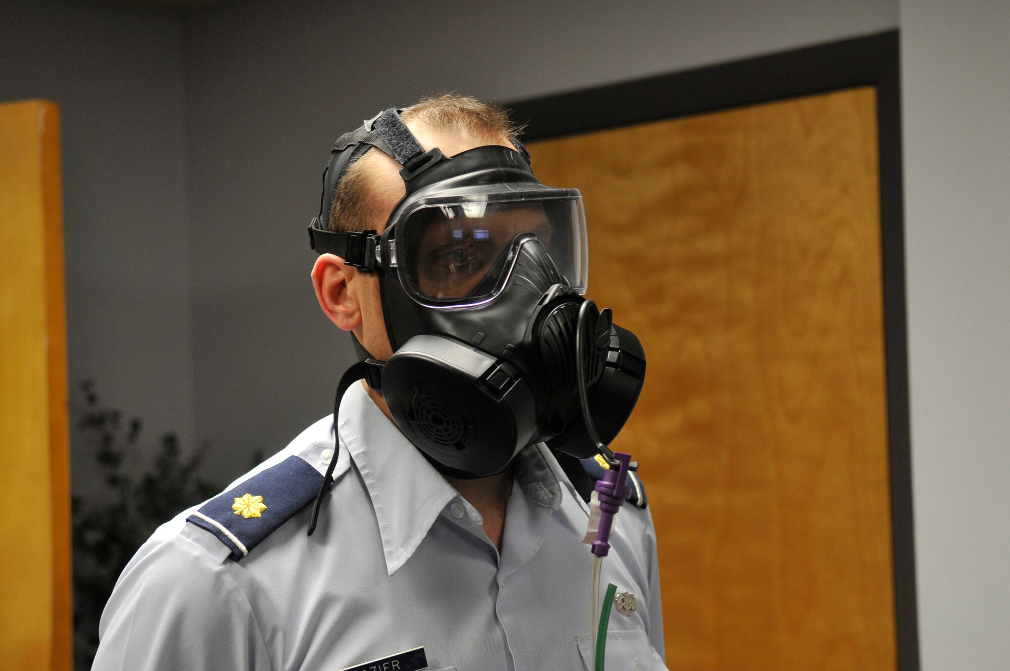 Maj. David Cazier breaths normally as he is fitted for a gas mask Dec. 14, 2009, Eielson Air Force Base, Alaska. The 354th Medical Group Bioengineering Flight set aside a day to visit each squadron and fit Airmen with the new M-50 gas mask. Major Cazier is assigned to the 354th Fighter Wing Legal Office. (U.S. Air Force photo/Airman 1st Class Janine Thibault)