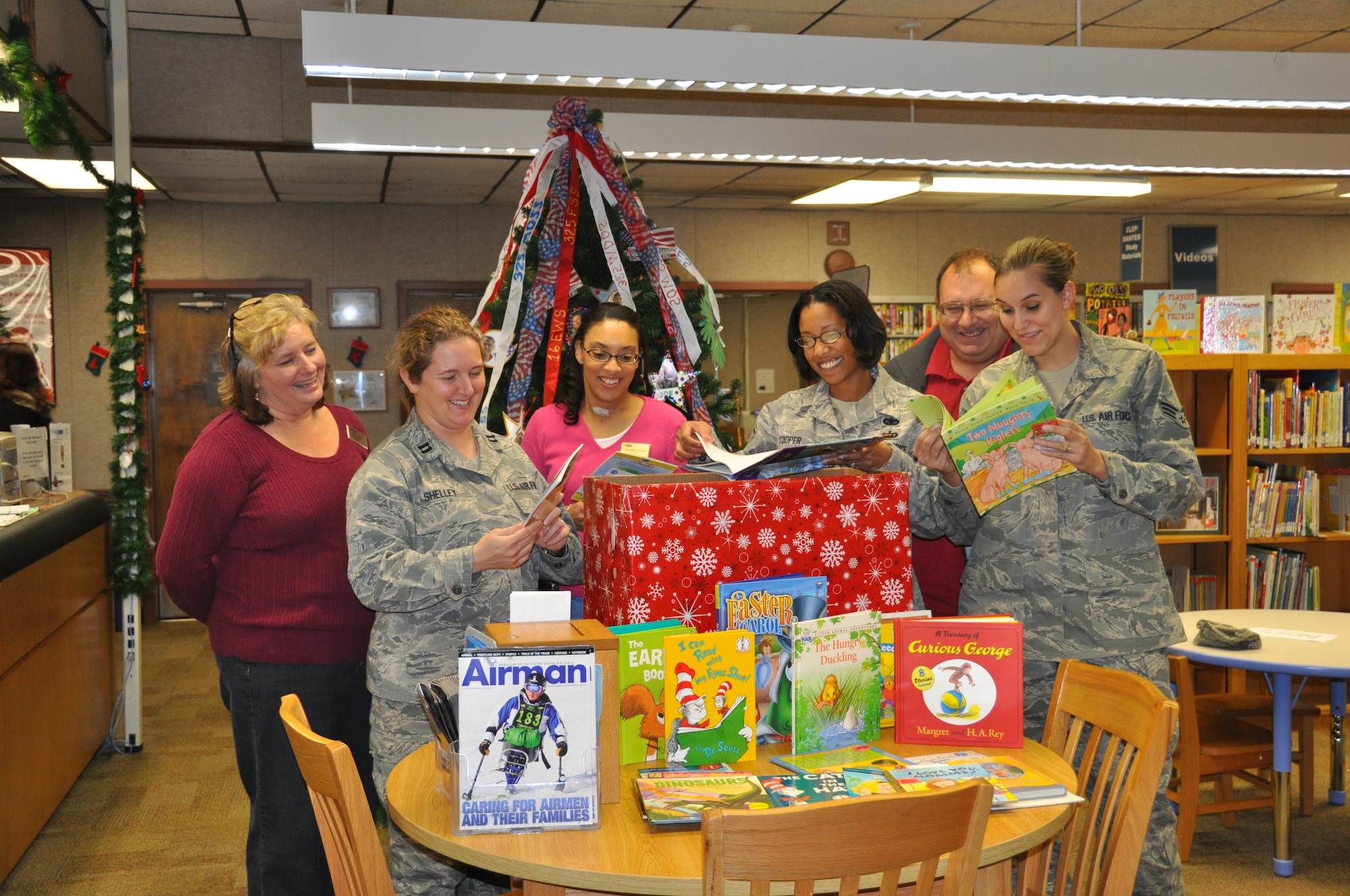 Airmen donate more than 100 new books to the library and the Child Development Center Dec. 11.  The books were collected from Team Tyndall members as part of a holiday book drive.  (U.S. Air Force photo/Senior Airman Veronica McMahon)

