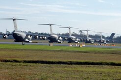 C-17 aircraft from Charleston AFB line up for take-off in preparation for a strategic brigade airdrop exercise over North Auxiliary Airfield near North, S.C., Dec. 16. Charleston AFB conducted a large formation exercise utilizing 10 C-17 aircraft. Soldiers from the 2-319th Airborne Field Artillery, 82nd Airborne Division, Ft. Bragg, N.C., were airdropped along with cargo pallets to simulate the seizure of a remote airfield. (U.S. Air Force photo/Staff Sgt. Marie Brown)(RELEASED)