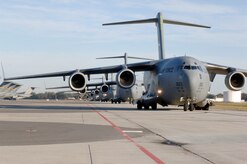 C-17 aircraft from Charleston AFB taxi prior to take-off in preparation for a strategic brigade airdrop exercise over North Auxiliary Airfield near North, S.C., Dec. 16. Airborne Soldiers from the 2-319th Airborne Field Artillery, 82nd Airborne Division, Ft. Bragg, N.C., were airdropped in the exercise along with cargo pallets to simulate the seizure of a remote airfield, providing a joint training opportunity for the Airmen and Soldiers. The training mission included airdrops over North Auxiliary Airfield, aerial refueling training and simulated aeromedical evacuation. (U.S. Air Force photo/Staff Sgt. Marie Brown)(RELEASED)