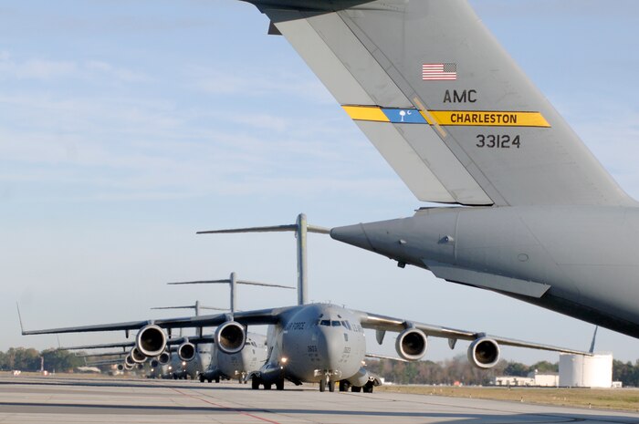 C-17 aircraft from Charleston AFB taxi prior to take-off in preparation for a strategic brigade airdrop exercise over North Auxiliary Airfield near North, S.C., Dec. 16. Charleston AFB conducted a large formation exercise utilizing 10 C-17 aircraft. Soldiers from the 2-319th Airborne Field Artillery, 82nd Airborne Division, Ft. Bragg, N.C., were airdropped along with cargo pallets to simulate the seizure of a remote airfield. (U.S. Air Force photo/Staff Sgt. Marie Brown)(RELEASED)