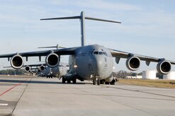 C-17 aircraft from Charleston AFB taxi prior to take-off in preparation for a strategic brigade airdrop exercise over North Auxiliary Airfield near North, S.C., Dec. 16. Airborne Soldiers from the 2-319th Airborne Field Artillery, 82nd Airborne Division, Ft. Bragg, N.C., were airdropped in the exercise along with cargo pallets to simulate the seizure of a remote airfield, providing a joint training opportunity for the Airmen and Soldiers. The training mission included airdrops over North Auxiliary Airfield, aerial refueling training and simulated aeromedical evacuation. (U.S. Air Force photo/Staff Sgt. Marie Brown)(RELEASED)