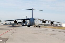 C-17 aircraft from Charleston AFB taxi prior to take-off in preparation for a strategic brigade airdrop exercise over North Auxiliary Airfield near North, S.C., Dec. 16. Charleston AFB conducted a large formation exercise utilizing 10 C-17 aircraft. Soldiers from the 2-319th Airborne Field Artillery, 82nd Airborne Division, Ft. Bragg, N.C., were airdropped along with cargo pallets to simulate the seizure of a remote airfield. (U.S. Air Force photo/Staff Sgt. Marie Brown)(RELEASED)