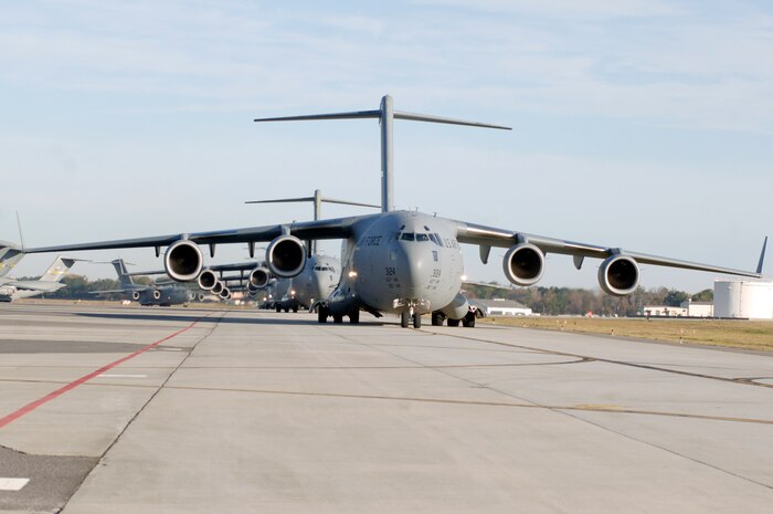 C-17 aircraft from Charleston AFB taxi prior to take-off in preparation for a strategic brigade airdrop exercise over North Auxiliary Airfield near North, S.C., Dec. 16. Charleston AFB conducted a large formation exercise utilizing 10 C-17 aircraft. Soldiers from the 2-319th Airborne Field Artillery, 82nd Airborne Division, Ft. Bragg, N.C., were airdropped along with cargo pallets to simulate the seizure of a remote airfield. (U.S. Air Force photo/Staff Sgt. Marie Brown)(RELEASED)