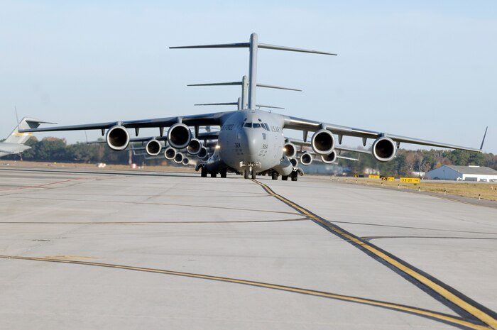 C-17 aircraft from Charleston AFB taxi prior to take-off, in preparation for a strategic brigade airdrop exercise over North Auxiliary Airfield near North, S.C., Dec. 16, demonstrating the global projection of U.S. airpower. Airborne Soldiers from the 2-319th Airborne Field Artillery, 82nd Airborne Division, Ft. Bragg, N.C., were airdropped in the exercise along with cargo pallets to simulate the seizure of a remote airfield, providing a joint training opportunity for the Airmen and Soldiers. The training mission included airdrops over North Auxiliary Airfield, aerial refueling training and simulated aeromedical evacuation. (U.S. Air Force photo/Staff Sgt. Marie Brown)