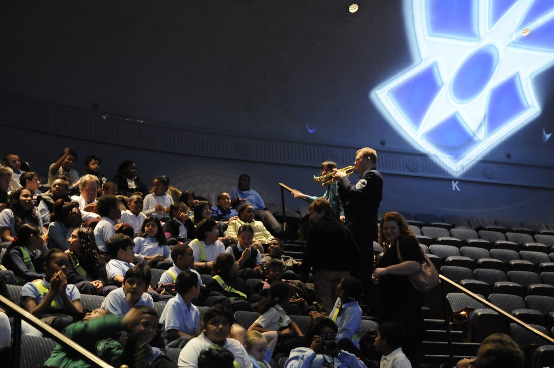 Senior Master Sgt. Curt Christensen, a member of the Concert Band’s trumpet section, answers questions during a demonstration to local students before this year’s children’s holiday program.  Over 2,000 area school children attended the performance at Daughter’s of the American Revolution Constitution Hall in Washington, D.C.  This year’s program, “Hooray for Holidays”, featured holiday music from stage, screen, and television. (Photo by A1C Alex Montes)
