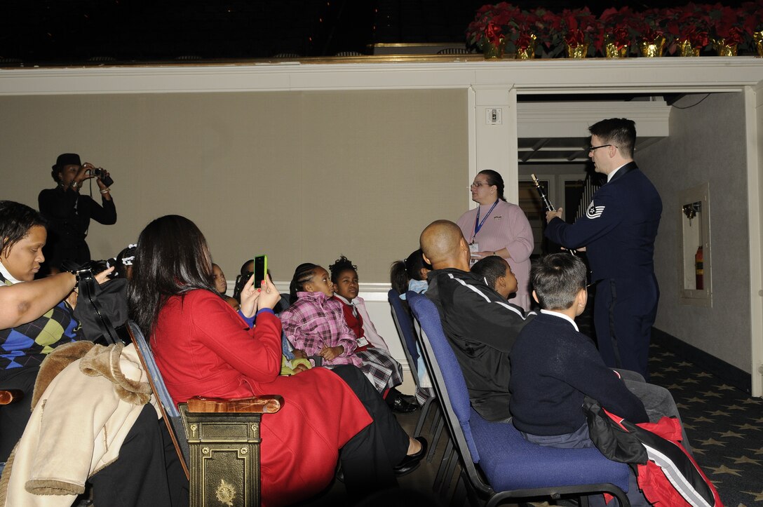 Technical Sgt. Darrin Thiriot, a clarinetist in the Concert Band, provides a musical demonstration to local students before this year’s children’s holiday program.  Over 2,000 area school children attended the performance at Daughter’s of the American Revolution Constitution Hall in Washington, D.C.  This year’s program, “Hooray for Holidays”, featured holiday music from stage, screen, and television.  (Photo by A1C Alex Montes)