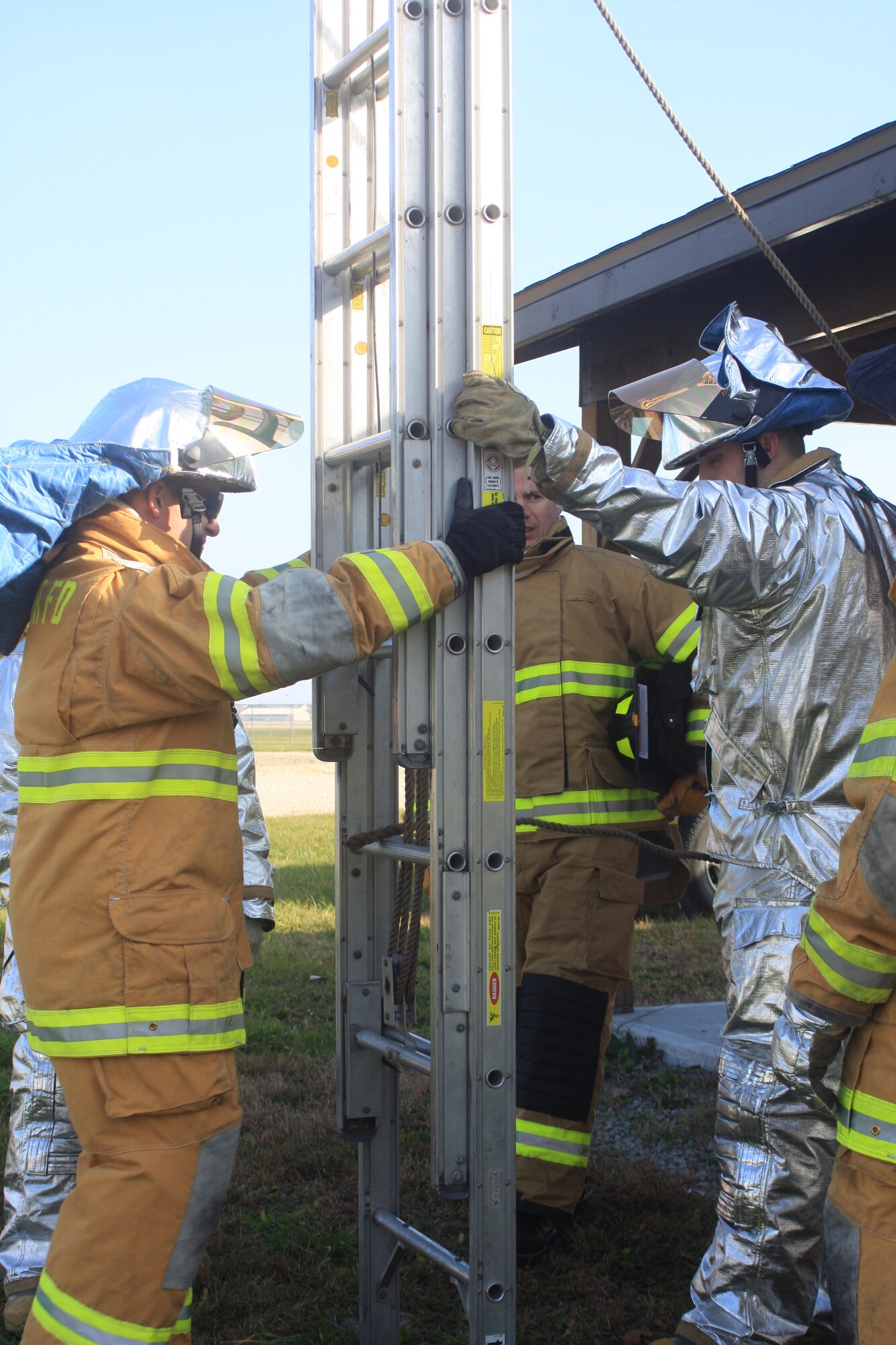 WRIGHT-PATTERSON AIR FORCE BASE, Ohio – Staff Sgt. Glen Beddies, on the left, and Staff Sgt. David Burt, both from the 445th Civil Engineer Squadron, practice ladder placement training Nov. 22 as Staff Sgt. Zach Hastings (in the foreground) looks on.  More than a dozen other fire fighters spent the day training on ventilation of structures, the deployment of ladders and structure rescue operations and reviewing the tools of the trade. (U.S. Air Force photo/Staff Sgt. Amanda Duncan)
