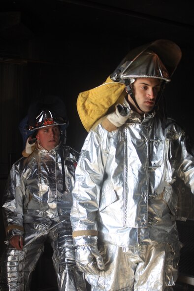 WRIGHT-PATTERSON AIR FORCE BASE, Ohio – From left to right; Staff Sgt. David Burt and Senior Airman Hugh Gibbs, 445th Civil Engineer Squadron, participate in training on ventilation of structures at the fire fighting training site Nov. 22.  More than a dozen other fire fighters spent the day training on ventilation of structures, the deployment of ladders and structure rescue operations and reviewing the tools of the trade. (U.S. Air Force photo/Staff Sgt. Amanda Duncan)