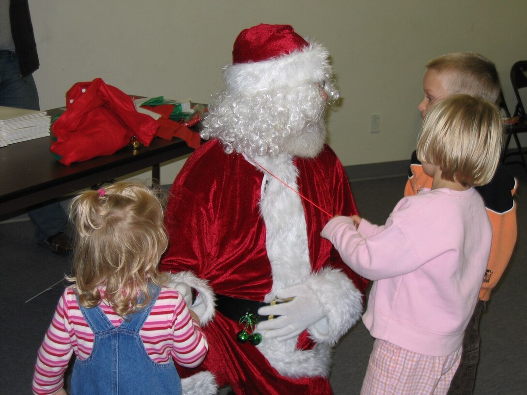 These three children along with several others went with many Arnold Engineering Development Center volunteers from the local International Brotherhood of Electrical Workers union to help them buy Christmas presents for siblings, family members or foster parents. More than 30 children were sponsored for this event. (Photo by Annette Painter)