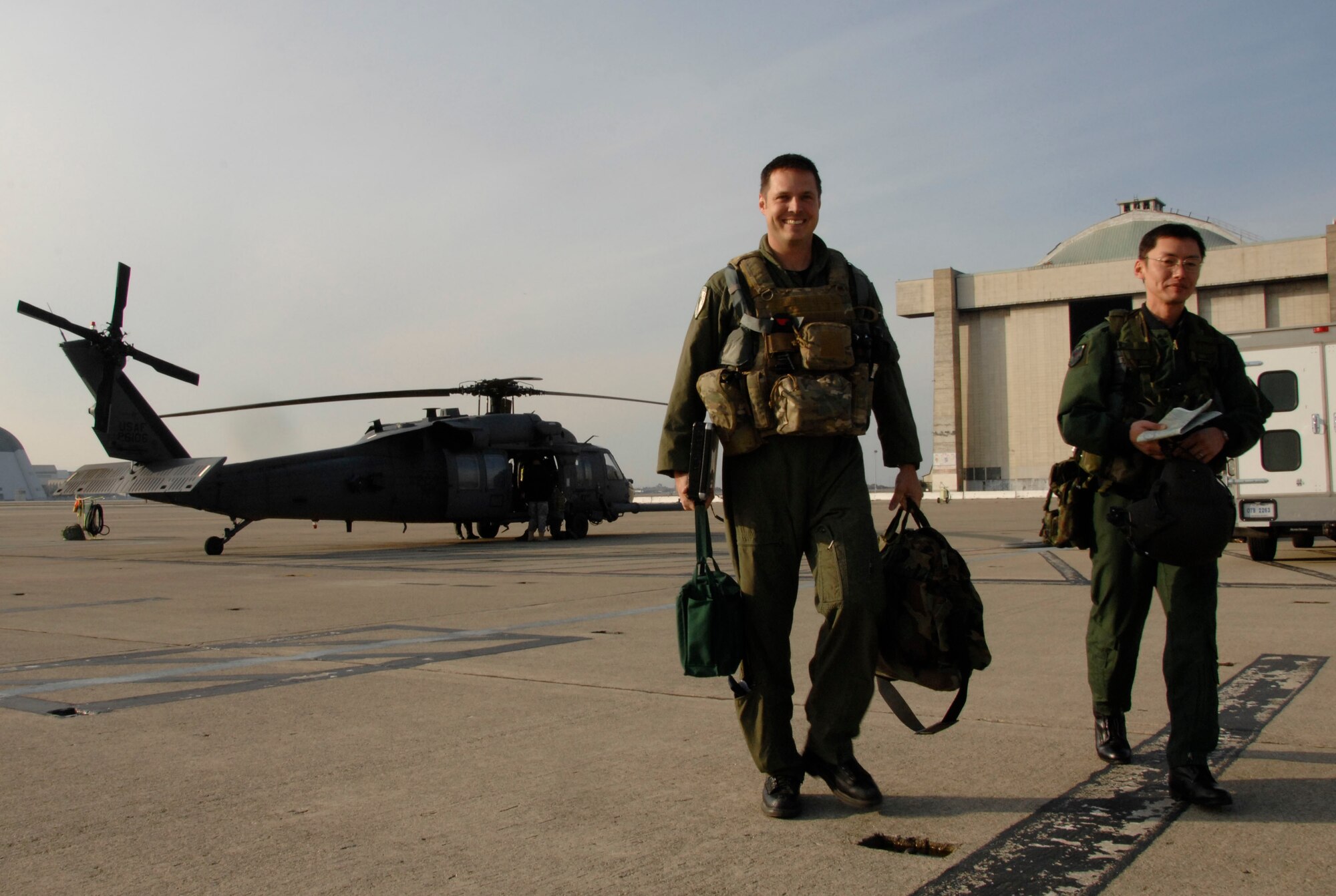 Maj. Mathew Wenthe, a 129th Rescue Squadron tactical officer with the 129th Rescue Wing, Moffett Federal Airfield Calif., and Maj. Eiji Sekine, a Japan Air Self-Defense Force UH-60J pilot with the Air Rescue Wing at Komaki Air Base, Japan, walk away from the HH-60G Pave Hawk after air refueling training Dec. 9, 2009. (Air National Guard photo by Tech. Sgt. Ray Aquino)