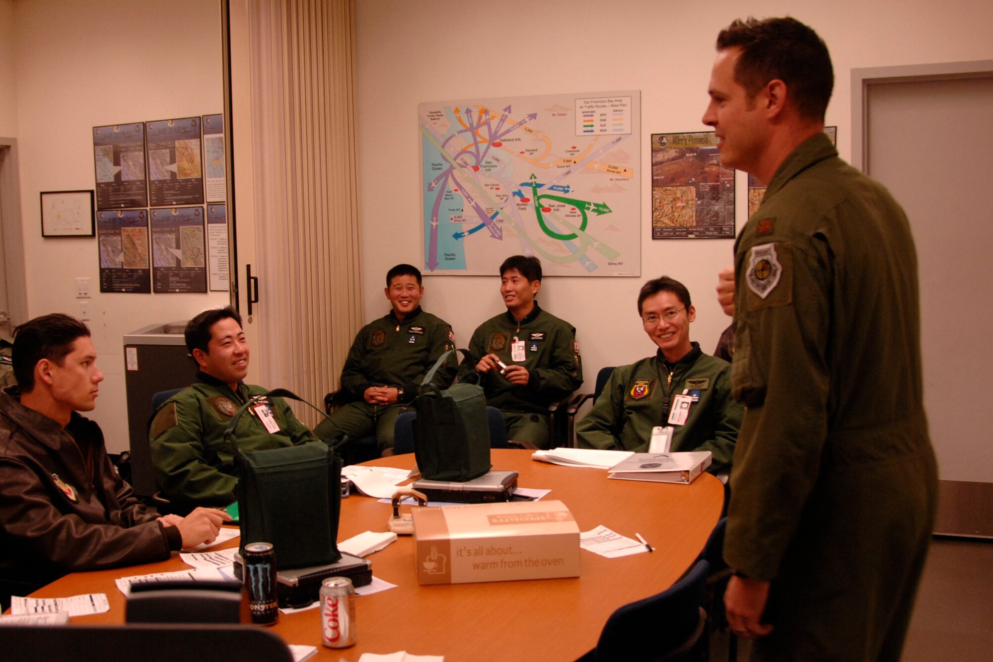 Maj. Mathew Wenthe, a 129th Rescue Squadron tactical officer with the 129th Rescue Wing, Moffett Federal Airfield, Calif,. briefs the Japan Air Self-Defense Force pilots visiting from Komaki Air Base, Japan, about their air refueling training Dec. 10, 2009. (Air National Guard photo by Tech. Sgt. Ray Aquino)