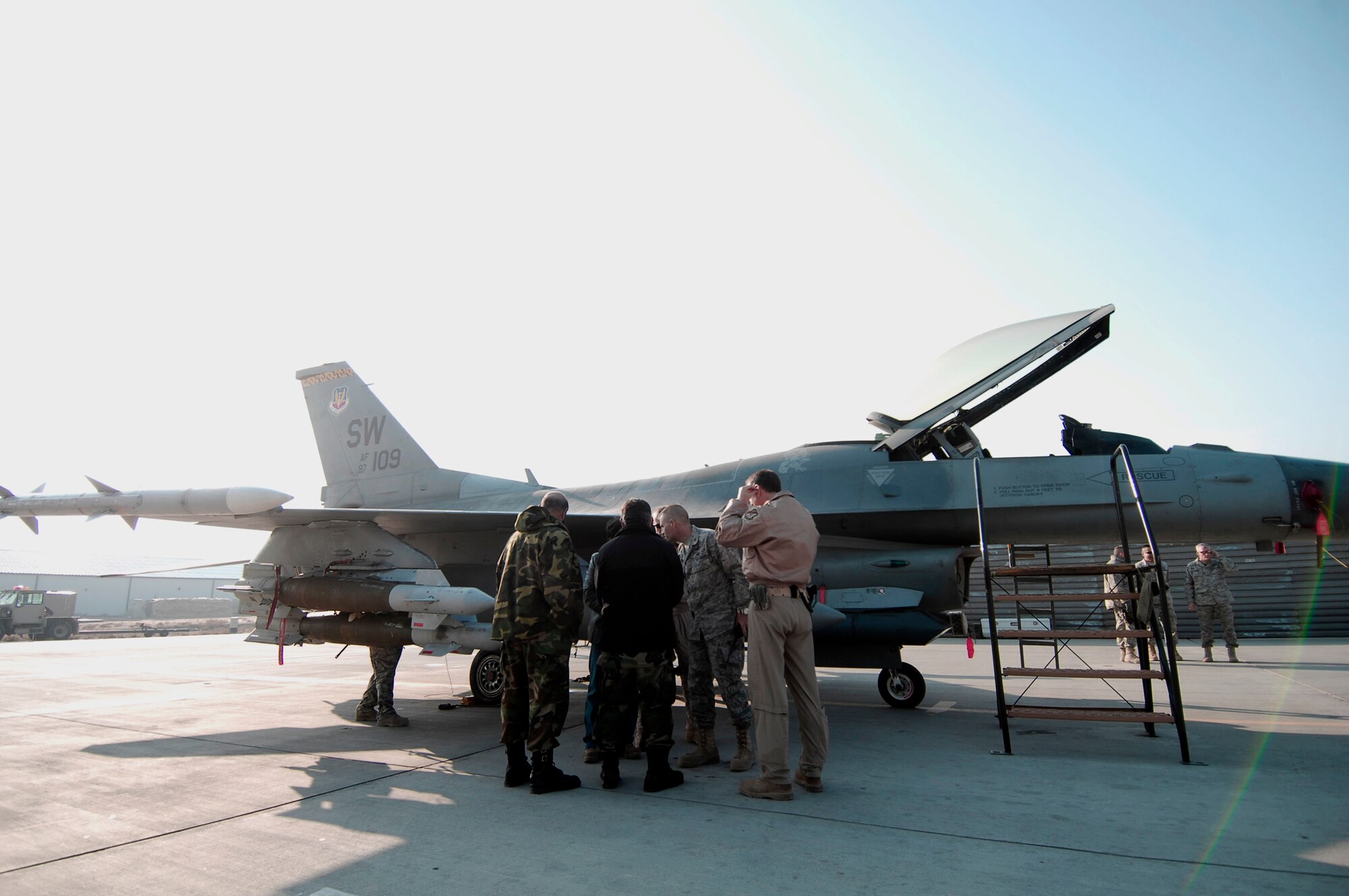 Brig. Gen. Steven L. Kwast, the 455th Air Expeditionary Wing commander, explains how a seeker-head on the front of laser-guided bomb directs the bomb to its target to Brig. Gen. Abdul Wahab Wardak, the Afghan National Army Air Corps chief of staff Dec. 19, 2009, at Bagram Airfield, Aghanistan. General Wardak and a delegation of Afghan National Army Air Corps officials visited with the 455th Air Expeditionary Wing to discuss close-air support-operations, air traffic control, maintenance, weapons loading procedures and cargo processing procedures. (U.S. Air Force photo/Capt. David Faggard)
