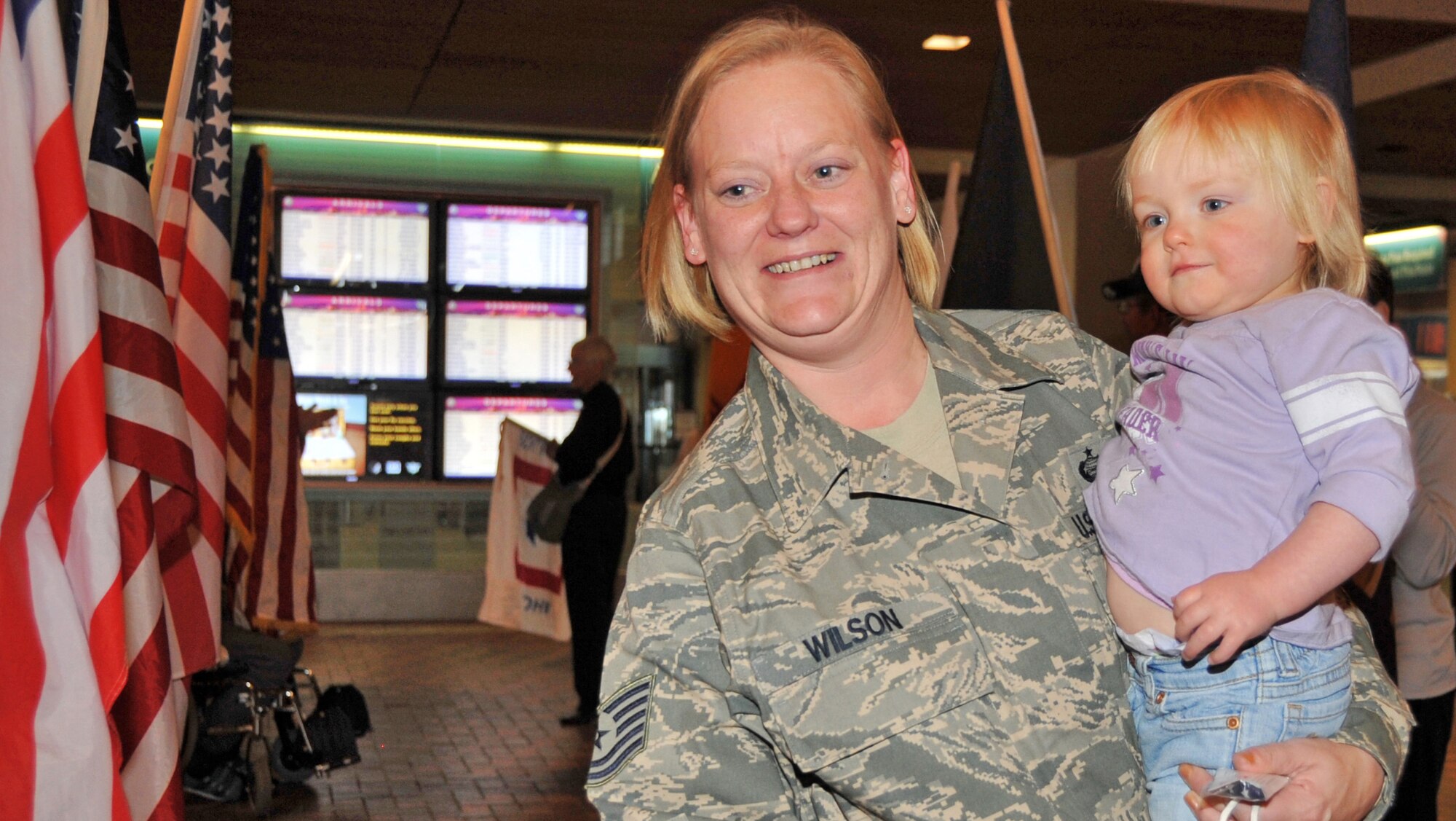 Tech. Sgt. Kellie Wilson, 377th Force Support Sqadron, Kirtland Air Force Base, New Mexico, with daughter Jadyn received a warm welcome home from friends, family and the Blue Star Mothers Dec.3 at the Albuquerque International Sunport.